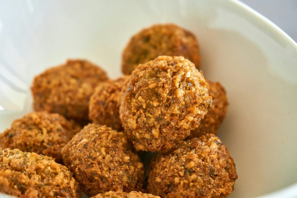 Close-up of homemade nut-free energy balls in a white bowl